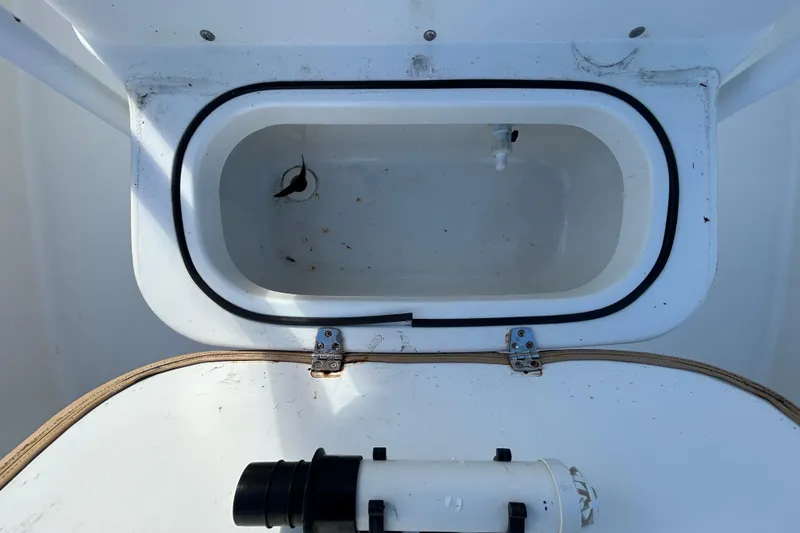 Slide: The Image of Open storage compartment on 2016 NauticStar 25 XS boat, showing interior details. - 83