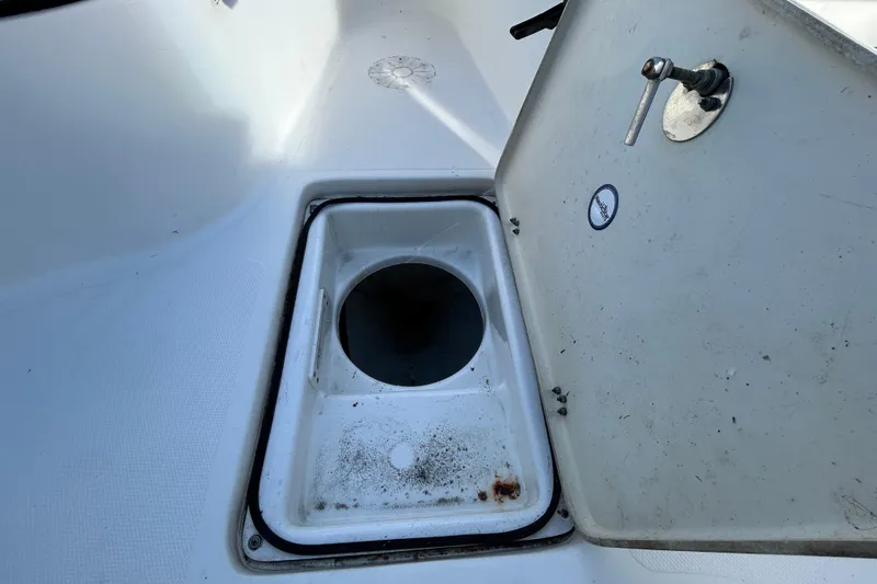 Slide: The Image of Open storage compartment on 2016 NauticStar 25 XS boat deck. - 85