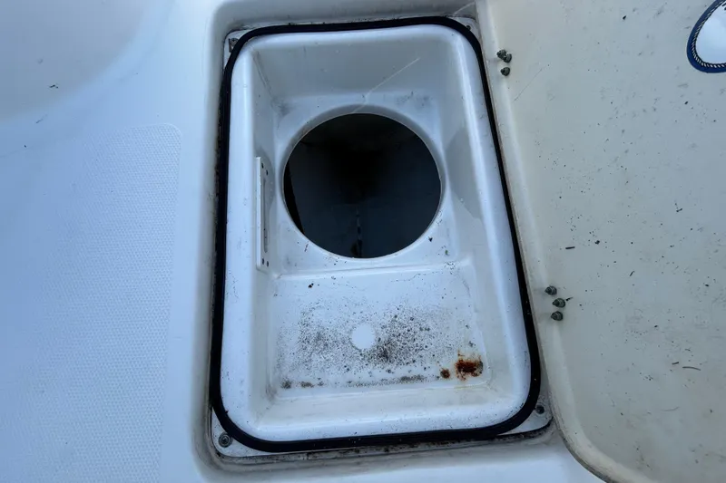 Slide: The Image of Open storage compartment on 2016 NauticStar 25 XS boat, showing interior details. - 86