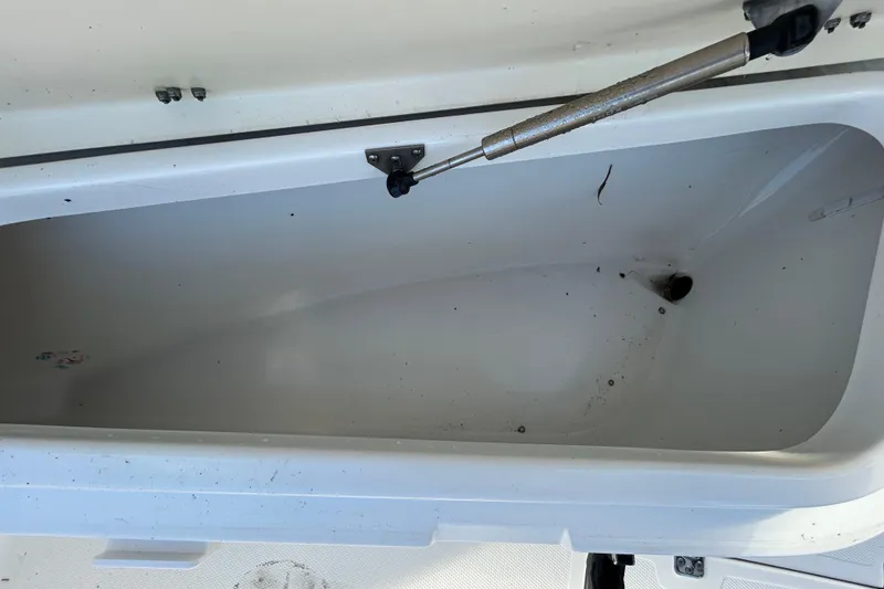 Slide: The Image of Open storage compartment on a 2016 NauticStar 25 XS boat. - 89