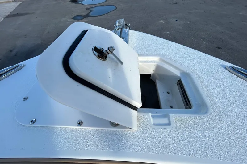Slide: The Image of 2016 NauticStar 25 XS boat anchor locker with open hatch on deck. - 91