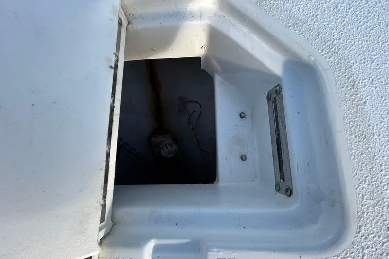 Slide: The Image of 2016 NauticStar 25 XS anchor locker with chain and wiring visible. - 92