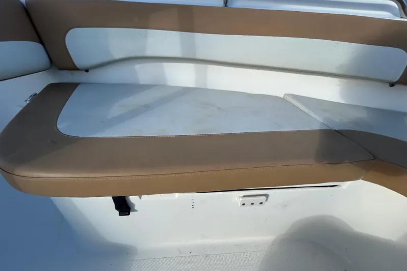 Slide: The Image of 2016 NauticStar 25 XS boat interior seating with tan and white upholstery. - 93