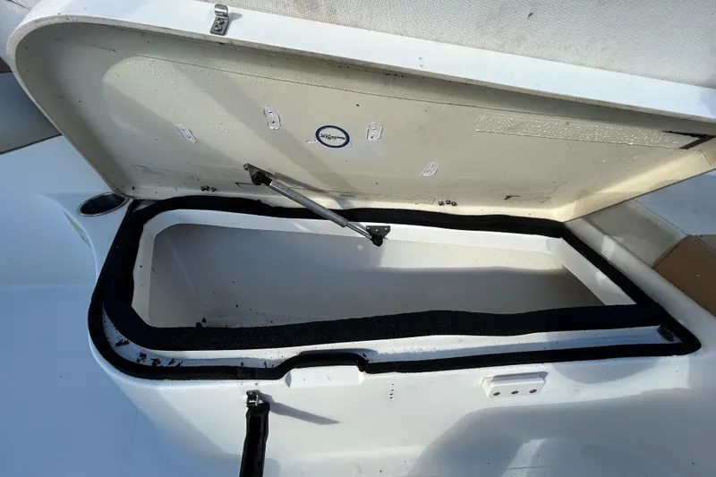 Slide: The Image of Open storage compartment on a 2016 NauticStar 25 XS boat. - 94