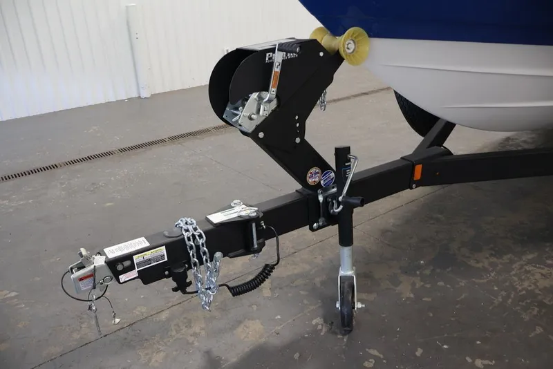 Slide: The Image of Trailer hitch of 2026 Yamaha Boats 255XE, featuring secure chains and wheel jack. - 8