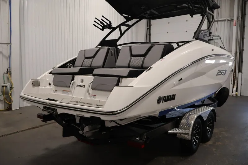 Slide: The Image of 2026 Yamaha Boats 255XE in a garage, showcasing sleek design and modern features. - 10