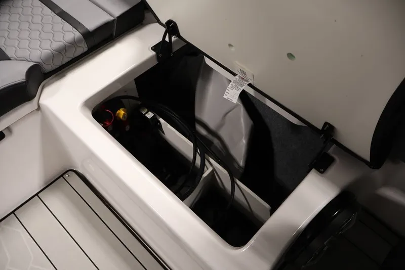Slide: The Image of Open storage compartment in 2026 Yamaha Boats 255XE, showcasing interior design and seating. - 30