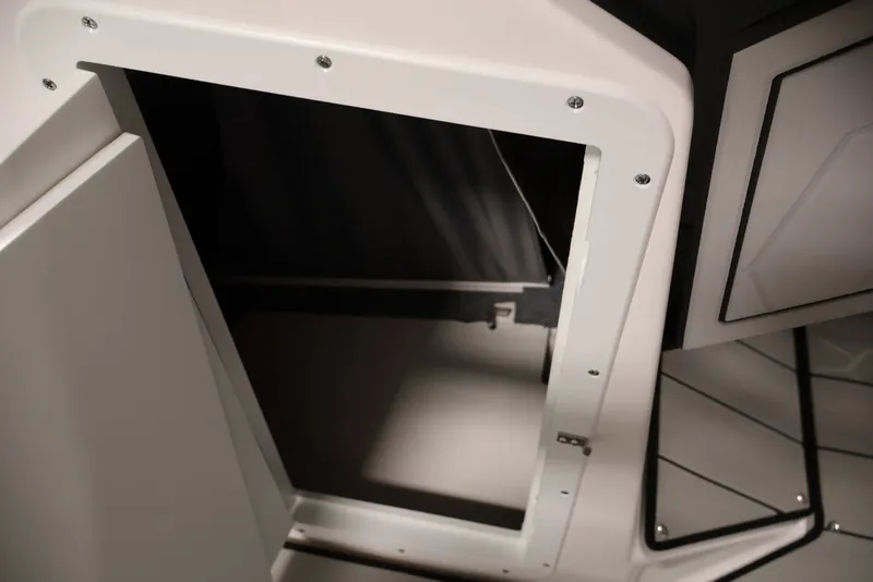 Slide: The Image of 2026 Yamaha Boats 255XE interior storage compartment, showcasing sleek design and functionality. - 43