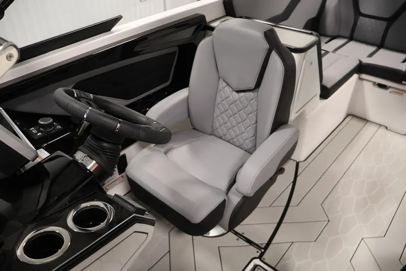 Slide: The Image of 2026 Yamaha Boats 255XE interior with sleek steering wheel and modern seating design. - 21