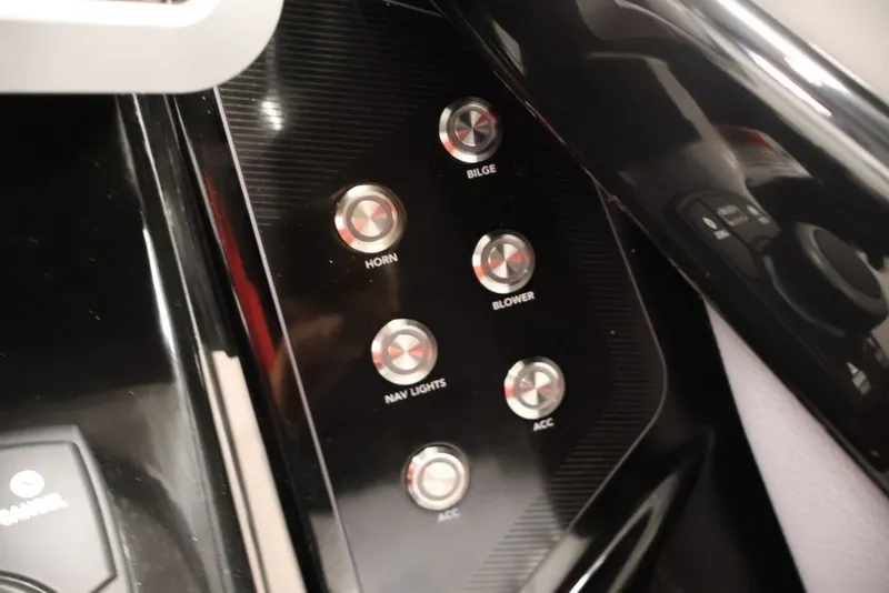 Slide: The Image of Control panel of 2026 Yamaha Boats 255XE featuring horn, bilge, blower, and navigation lights. - 38