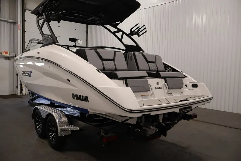 Slide: The Image of 2026 Yamaha Boats 255XE in a showroom, showcasing sleek design and modern features. - 57