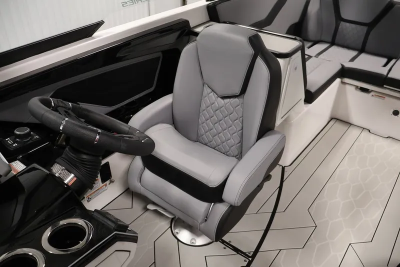 Slide: The Image of 2026 Yamaha Boats 255XE interior with sleek steering and luxurious seating design. - 51