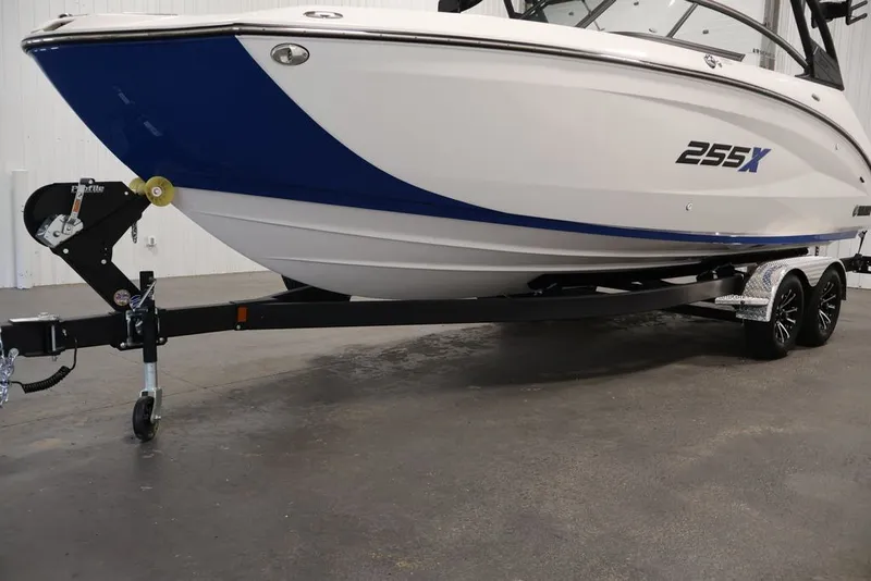 Slide: The Image of 2026 Yamaha Boats 255XE on trailer, featuring sleek white and blue design. - 33