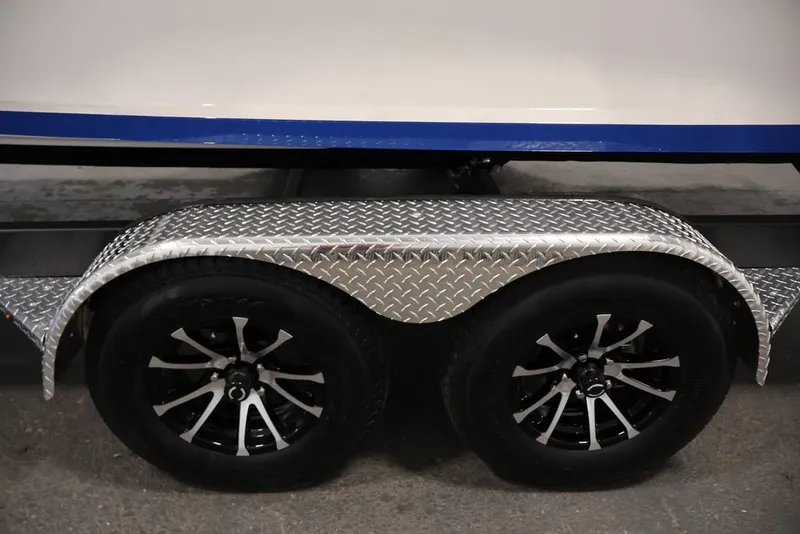 Slide: The Image of 2026 Yamaha Boats 255XE trailer with dual black alloy wheels and diamond plate fender. - 17
