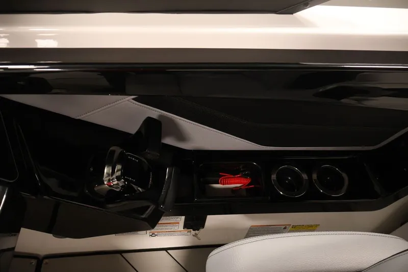Slide: The Image of Interior view of 2026 Yamaha Boats 255XE cockpit with controls and cup holders. - 54