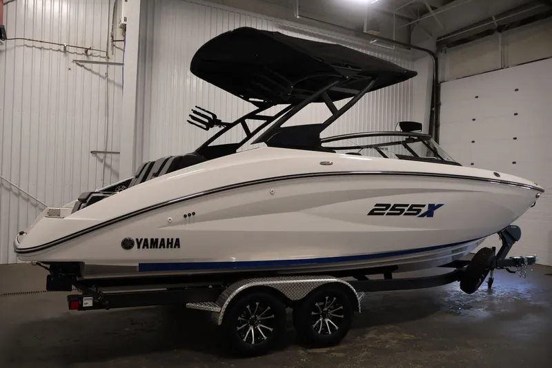 Slide: The Image of 2026 Yamaha Boats 255XE in a showroom, showcasing sleek design and modern features. - 6