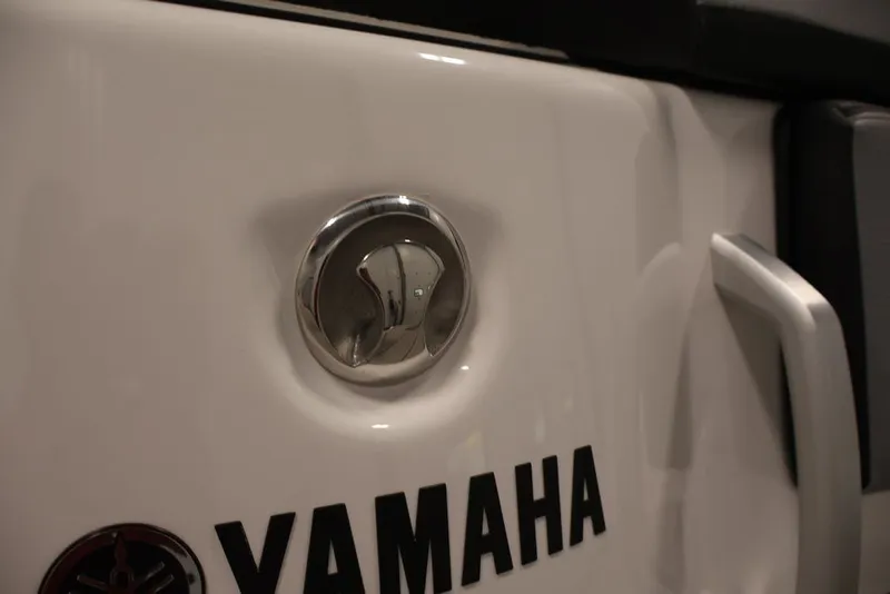 Slide: The Image of Close-up of 2026 Yamaha Boats 255XE logo and handle detail. - 9