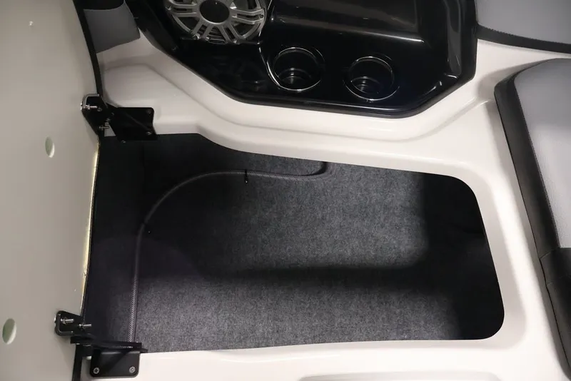 Slide: The Image of Interior storage compartment of 2026 Yamaha Boats 255XE with speaker and cup holders. - 41