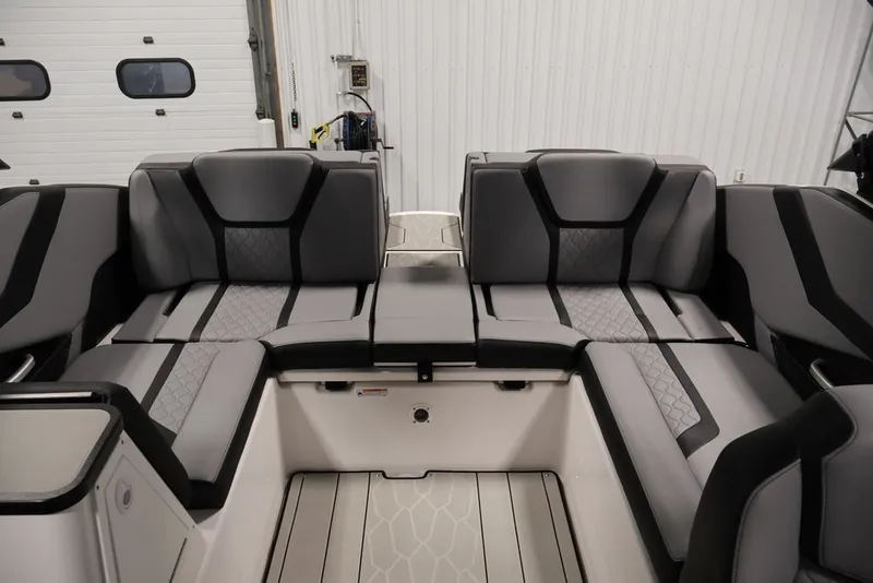 Slide: The Image of 2026 Yamaha Boats 255XE interior with sleek, modern seating design in a spacious layout. - 49