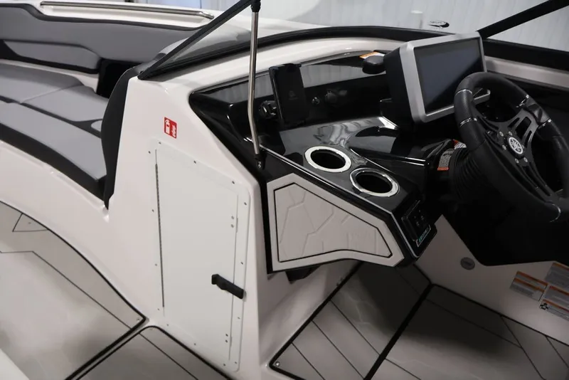Slide: The Image of 2026 Yamaha Boats 255XE interior with sleek dashboard and modern steering wheel design. - 52