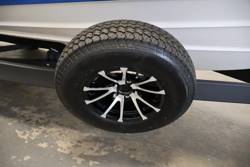 Slide: The Image of Trailer wheel of 2026 Yamaha Boats 255XE, featuring sleek black and silver design. - 23
