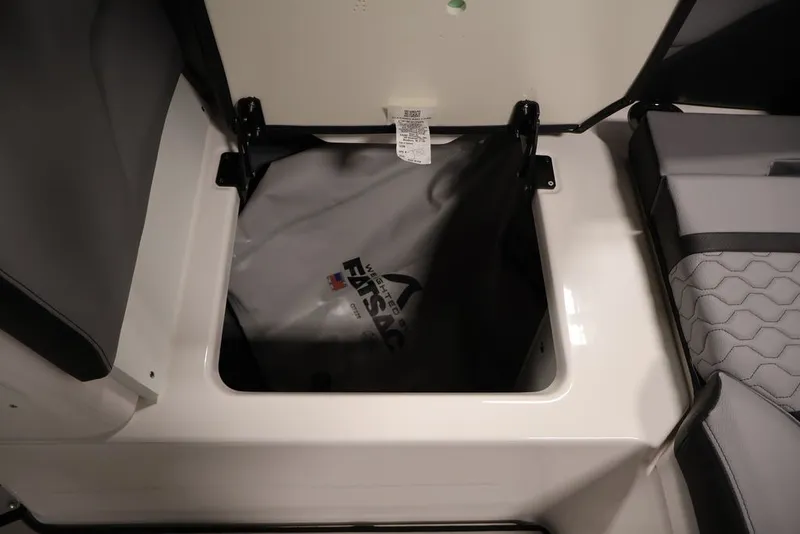 Slide: The Image of Storage compartment of 2026 Yamaha Boats 255XE with ballast bag visible. - 27