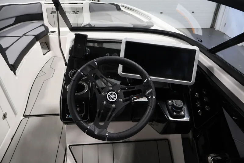 Slide: The Image of 2026 Yamaha Boats 255XE cockpit with steering wheel and touchscreen display. - 44