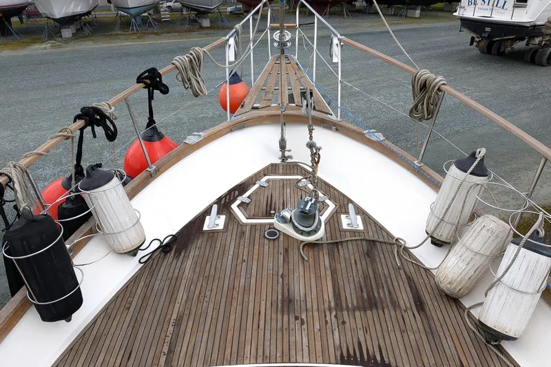 Slide: The Image of Bow of 1985 Siltala Nauticat 44 sailboat with deck equipment and fenders. - 10