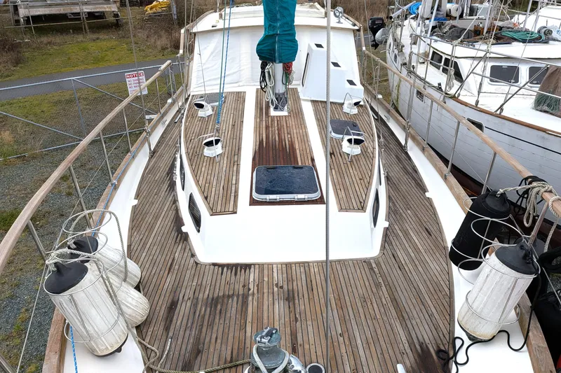 Slide: The Image of 1985 Siltala Nauticat 44 sailboat with wooden deck, docked in a marina. - 13
