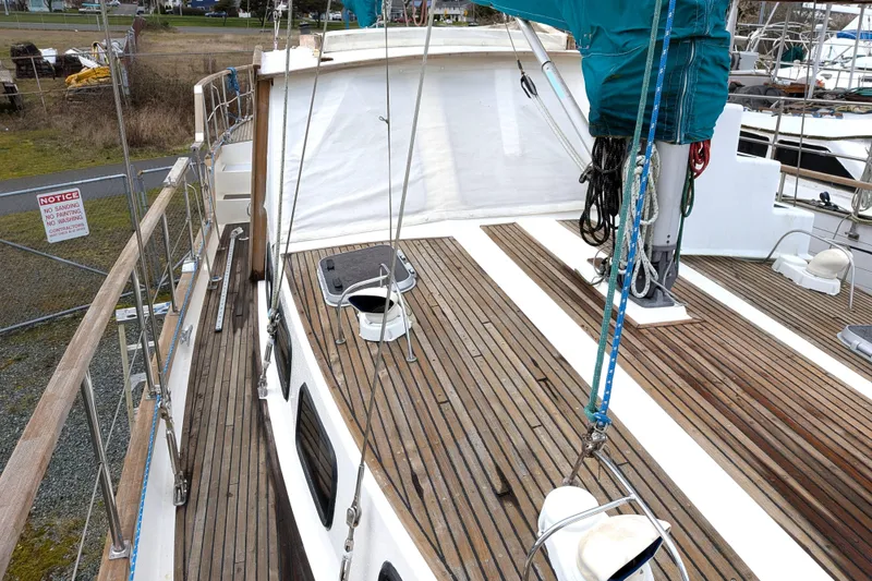 Slide: The Image of 1985 Siltala Nauticat 44 sailboat deck with wooden finish and rigging details. - 14