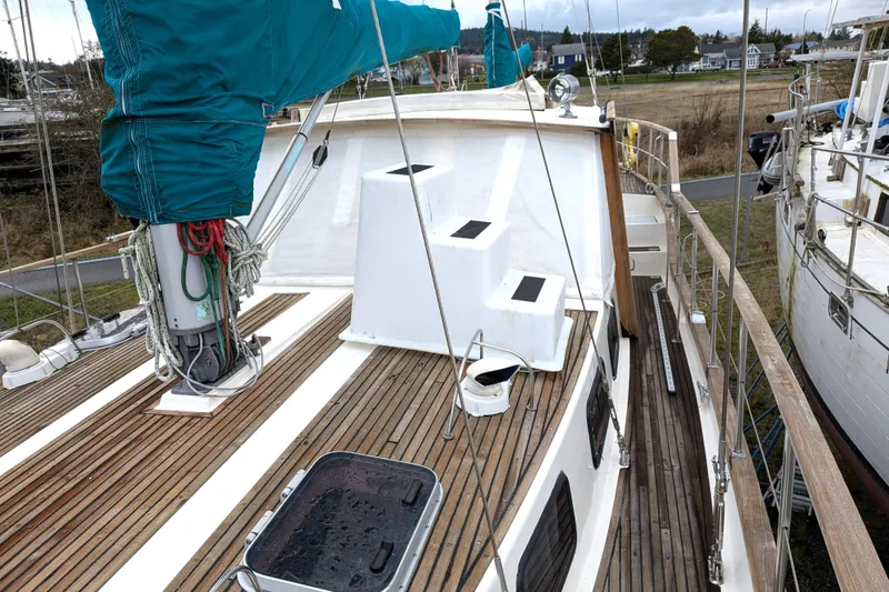 Slide: The Image of 1985 Siltala Nauticat 44 sailboat deck with wooden finish and covered mast. - 15
