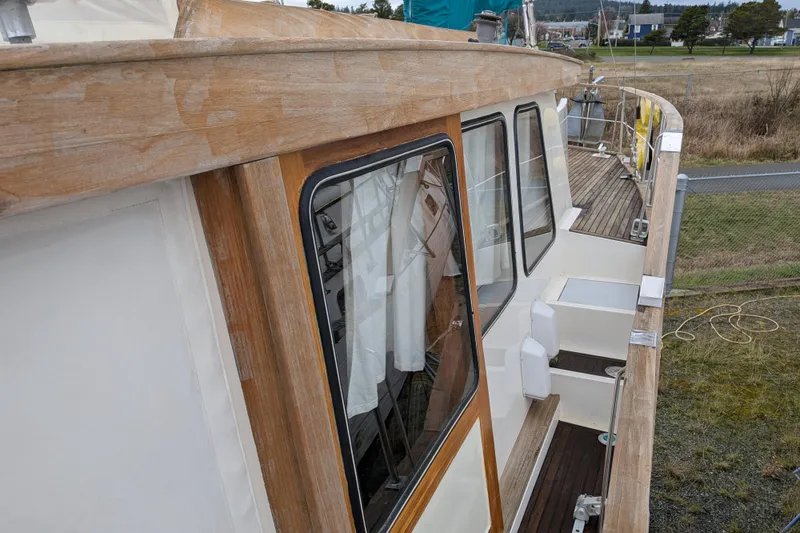 Slide: The Image of 1985 Siltala Nauticat 44 sailboat with wooden deck and cabin, docked outdoors. - 17