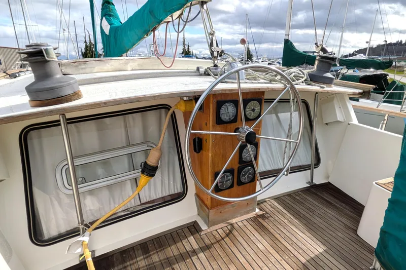 Slide: The Image of 1985 Siltala Nauticat 44 sailboat cockpit with steering wheel and navigation instruments. - 24