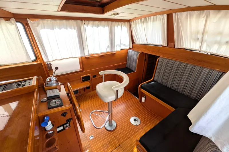 Slide: The Image of Interior of 1985 Siltala Nauticat 44 yacht with wooden finish and seating area. - 26