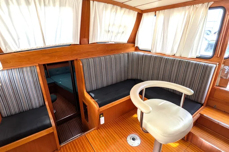 Slide: The Image of Interior of 1985 Siltala Nauticat 44 yacht with striped seating and wooden finishes. - 27