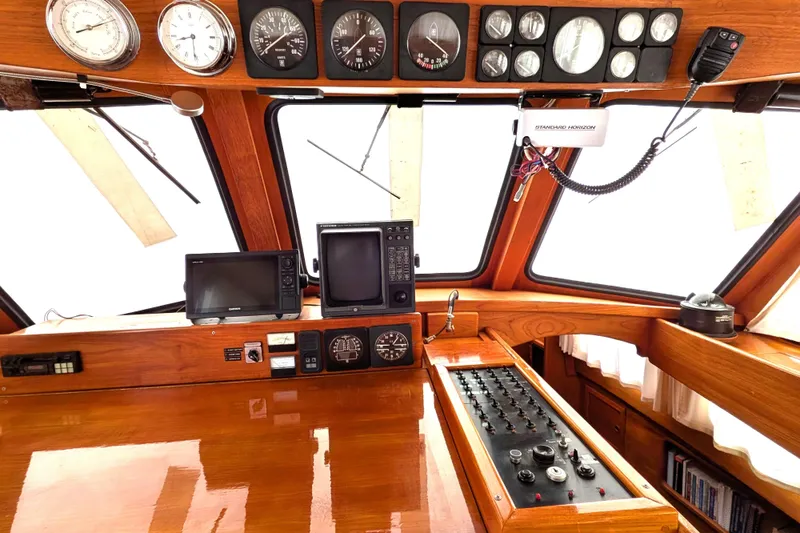 Slide: The Image of 1985 Siltala Nauticat 44 yacht cockpit with navigation instruments and wooden interior. - 32
