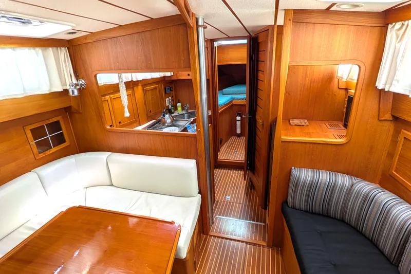 Slide: The Image of Interior of 1985 Siltala Nauticat 44 yacht with wood paneling and cozy seating area. - 36
