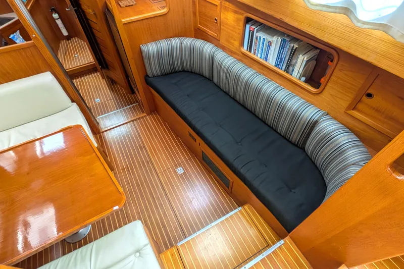Slide: The Image of Interior of 1985 Siltala Nauticat 44 yacht with wooden flooring and cozy seating area. - 40
