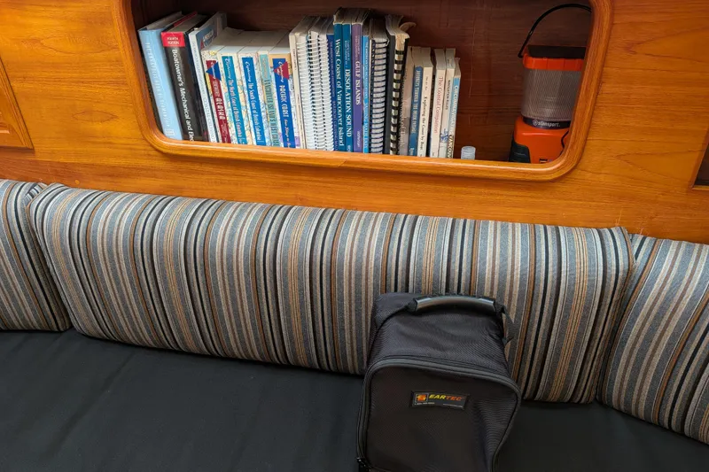 Slide: The Image of Cozy cabin interior of 1985 Siltala Nauticat 44 with books and striped cushions. - 41