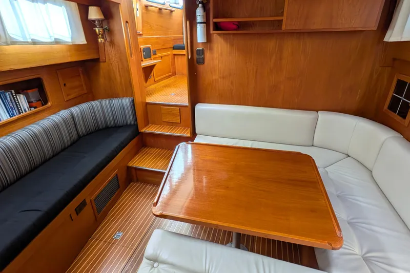 Slide: The Image of Interior of 1985 Siltala Nauticat 44 yacht with wooden table and cushioned seating. - 42