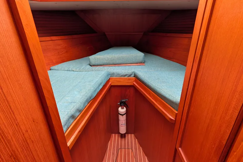 Slide: The Image of Cozy cabin interior of 1985 Siltala Nauticat 44 with blue cushions and wooden finish. - 46