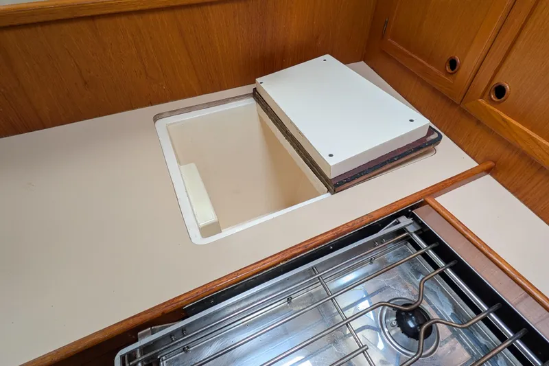 Slide: The Image of 1985 Siltala Nauticat 44 yacht kitchen with stove and storage compartment. - 48
