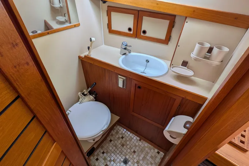 Slide: The Image of 1985 Siltala Nauticat 44 yacht bathroom with wooden cabinetry and compact design. - 50
