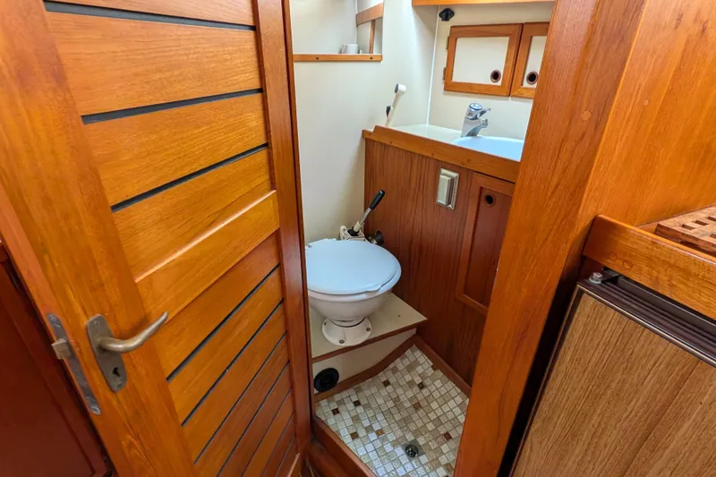 Slide: The Image of 1985 Siltala Nauticat 44 yacht bathroom with wooden interior and compact design. - 51