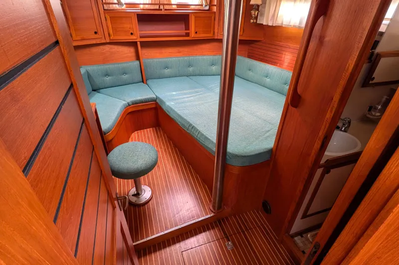 Slide: The Image of Cozy interior of 1985 Siltala Nauticat 44 yacht with teal seating and wooden finish. - 54