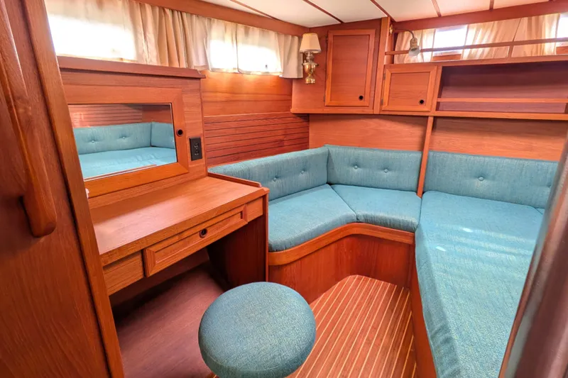 Slide: The Image of Cozy interior of 1985 Siltala Nauticat 44 yacht with wooden furnishings and teal seating. - 55