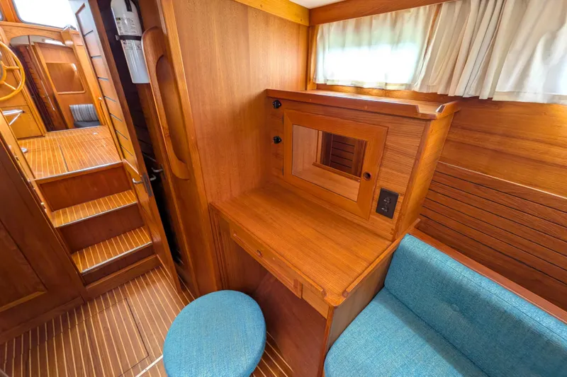 Slide: The Image of Interior of 1985 Siltala Nauticat 44 yacht with wooden desk and blue stool. - 57