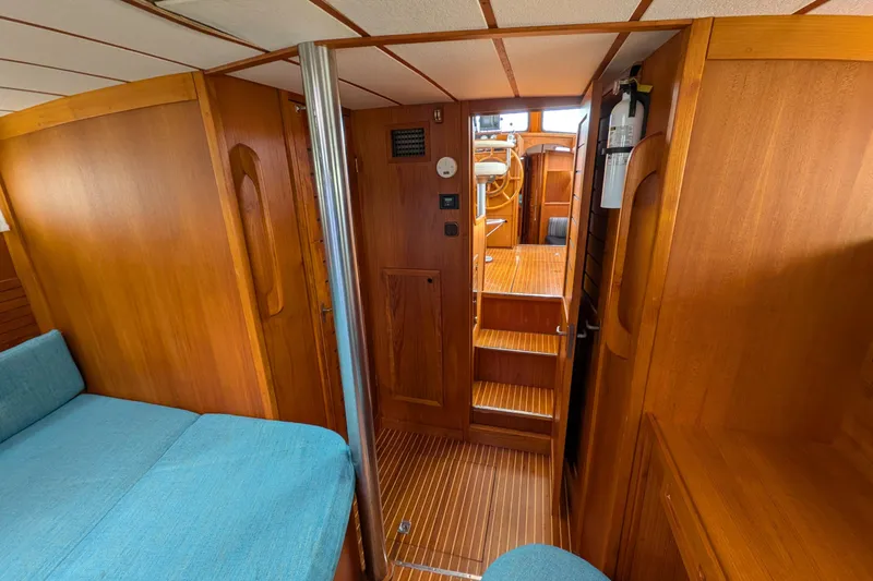 Slide: The Image of Interior of 1985 Siltala Nauticat 44 yacht with wooden finish and blue seating. - 58