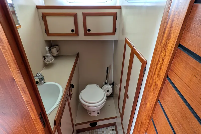 Slide: The Image of Bathroom interior of 1985 Siltala Nauticat 44 yacht, featuring wooden cabinetry and compact design. - 59