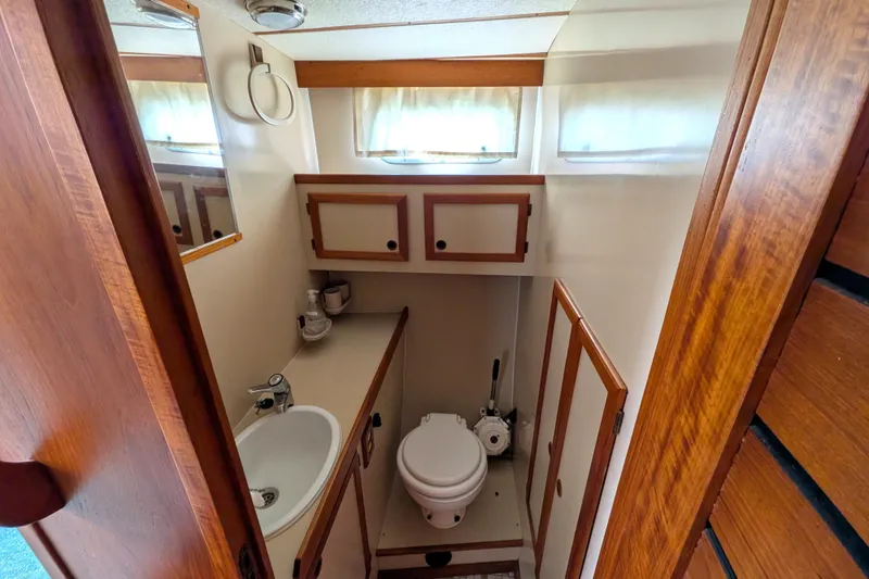 Slide: The Image of Compact bathroom in 1985 Siltala Nauticat 44 yacht with sink, toilet, and wooden cabinetry. - 61